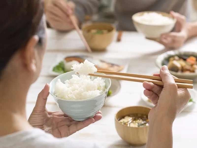 Một bữa ăn với chén cơm trắng và các món ăn kèm đa dạng