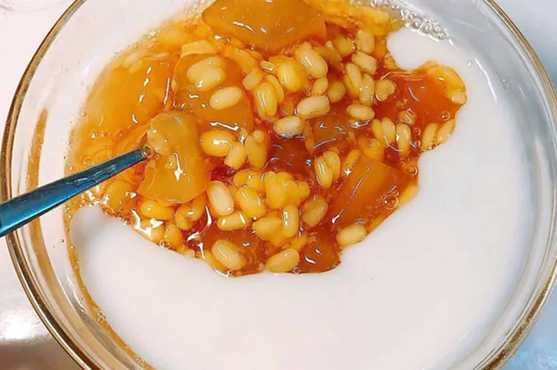 Một chén chè bưởi nhỏ đặt trên bàn, tượng trưng cho việc ăn uống điều độ.