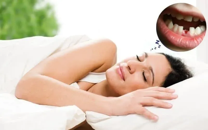 Một người phụ nữ lo lắng nhìn vào chiếc răng bị rụng trong lòng bàn tay